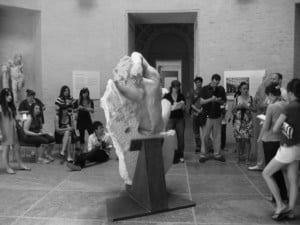 students studying a sculpture
